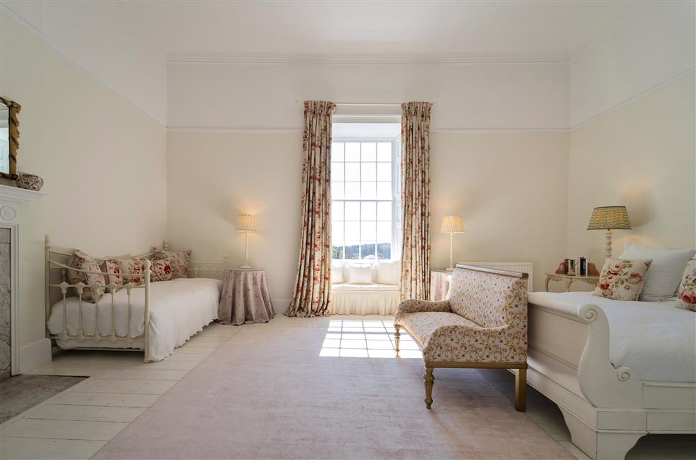 Large bedrooms with full-length windows offer beautiful views of the gardens and surrounding land at Butley Priory, Woodbridge