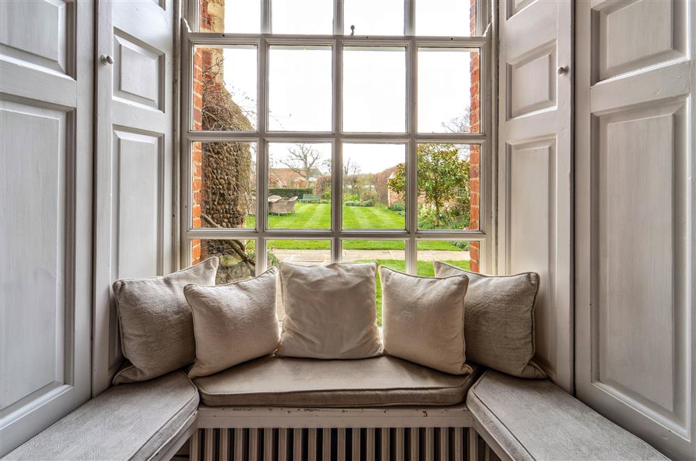 Settle at a window seat and observe the surrounding landscape at Butley Priory, Woodbridge