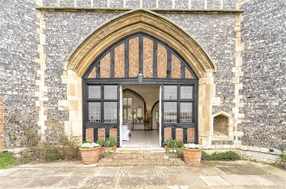 The Great Hall double French doors lead straight onto the patio and garden at Butley Priory, Woodbridge