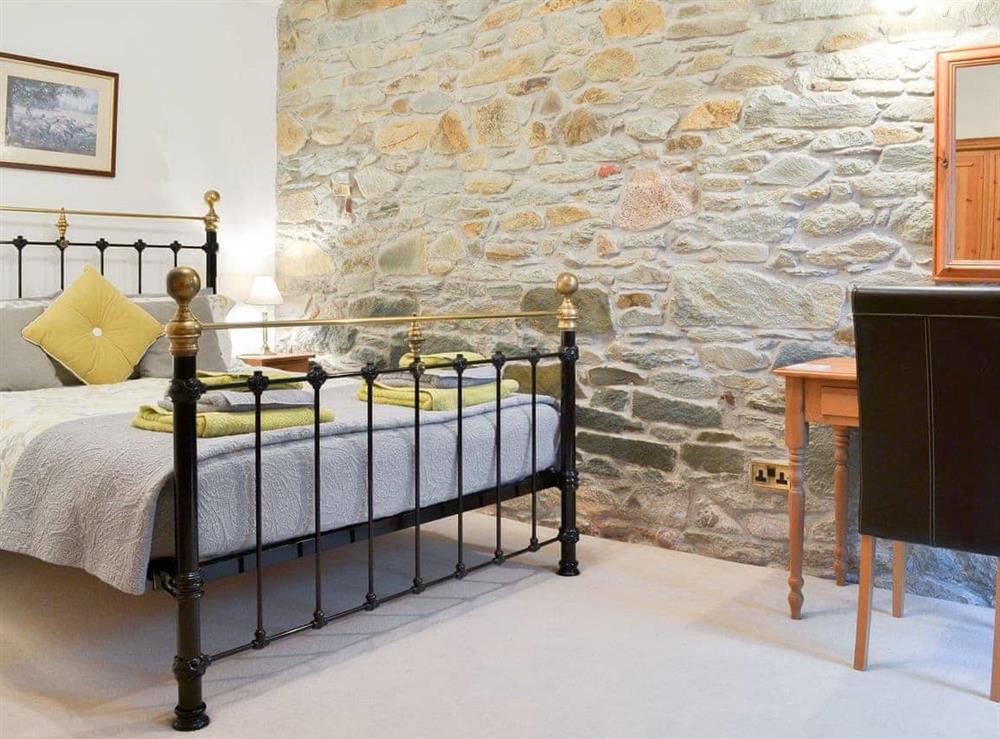 Delightful double bedded room with exposed stone wall
