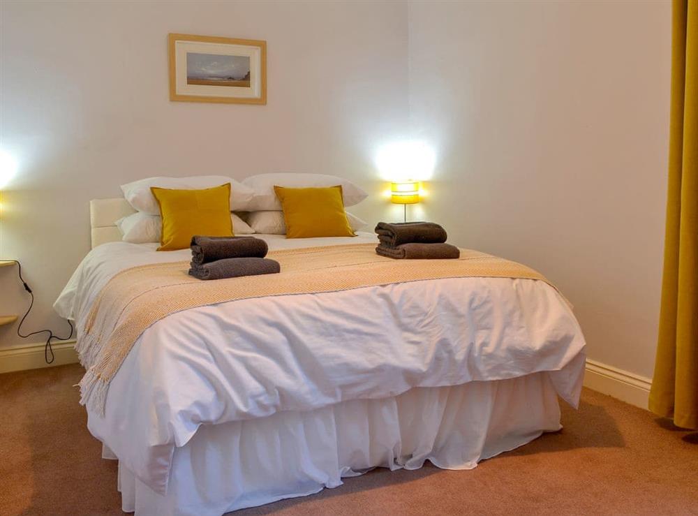 Relaxing bedroom with kingsize bed at Butterhole Cottage in Mabie, near Dumfries, Dumfriesshire