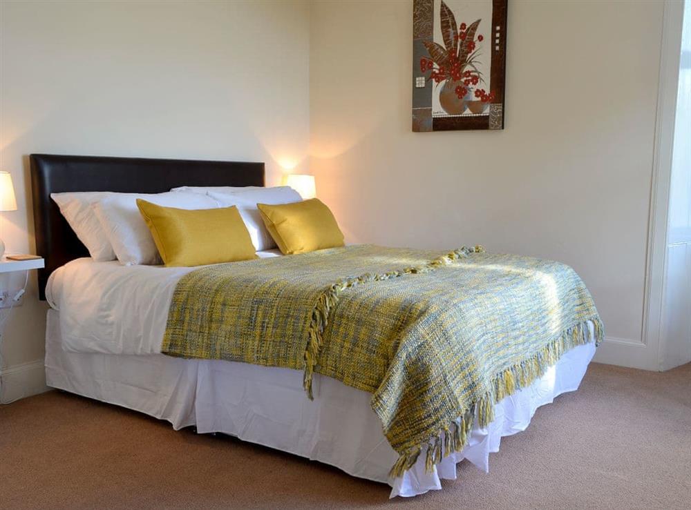 Relaxing bedroom with kingsize bed and en-suite at Butterhole Farmhouse in Mabie, near Dumfries, Dumfriesshire