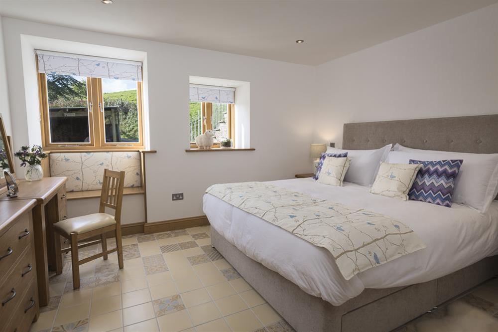 A spacious en suite master bedroom with super-King size bed at Butterwell Barn in , Nr Dartmouth