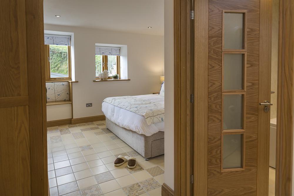Master bedroom with delightful mosaic tiled flooring and high quality shower/bath room at Butterwell Barn in , Nr Dartmouth