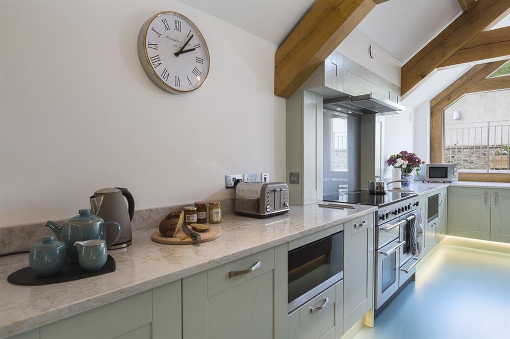 The kitchen has an extensive range of fitted wall and floor units and marble worktops at Butterwell Barn in , Nr Dartmouth