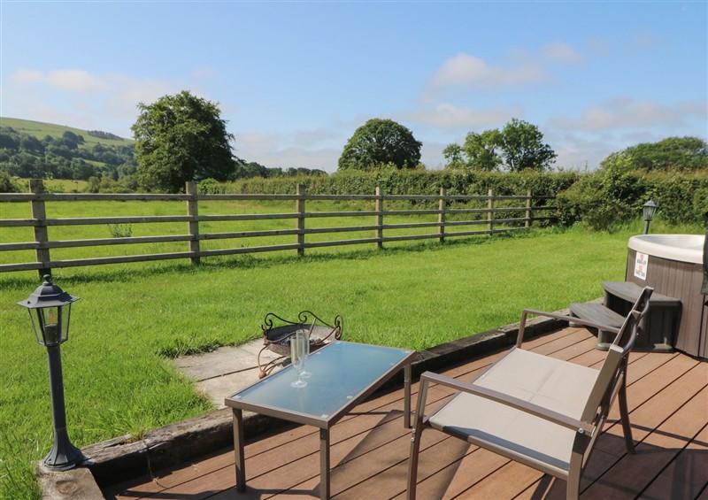 Enjoy a glass of wine on the patio at Bwthyn Bach Brefi, Llanddewi-Brefi