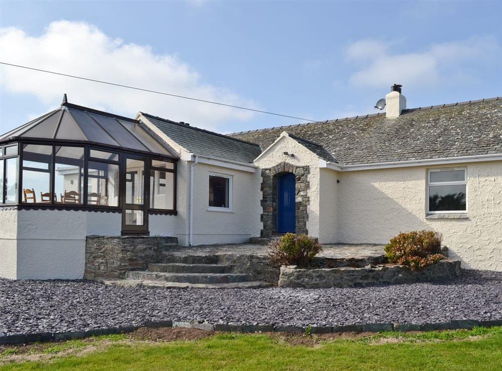Exterior with conservatory at Bwthyn Pereos in Cemaes Bay, Gwynedd