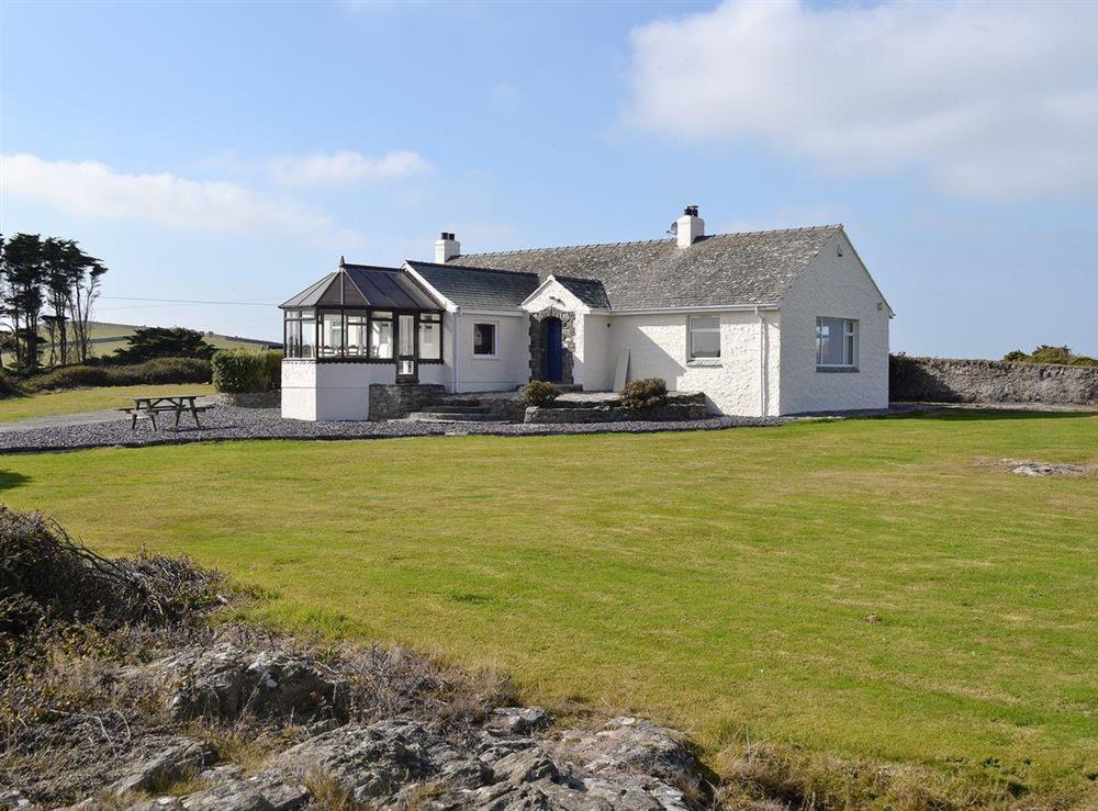 Impressive exterior situated  in a fantastic setting with commanding views of the sea at Bwthyn Pereos in Cemaes Bay, Gwynedd