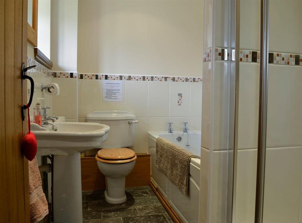 Bathroom with bath and shower cubicle at Bwythyn Clyd in Llangollen, near Wrexham, North Wales Borders, Denbighshire
