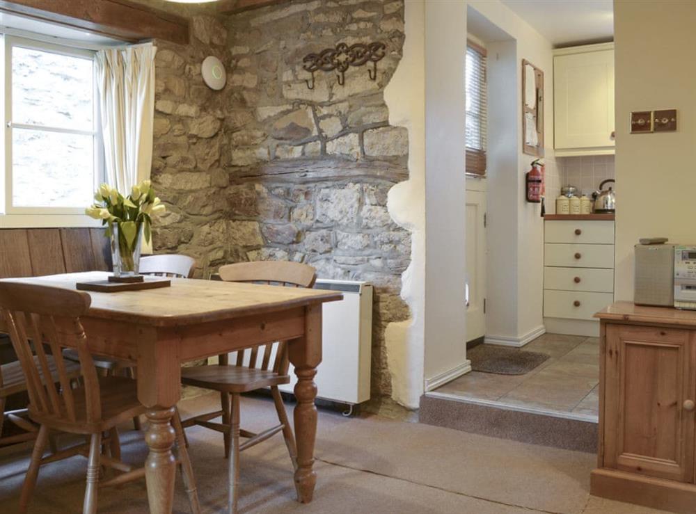 Convenient dining area with exposed stone walls at Byre Cottage in Hutton-le-Hole, near Kirkbymoorside, North Yorkshire
