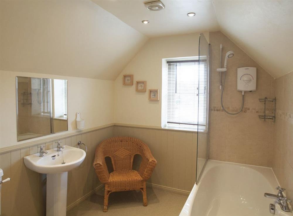 Spacious bathroom with shower over bath at Byre Cottage in Hutton-le-Hole, near Kirkbymoorside, North Yorkshire