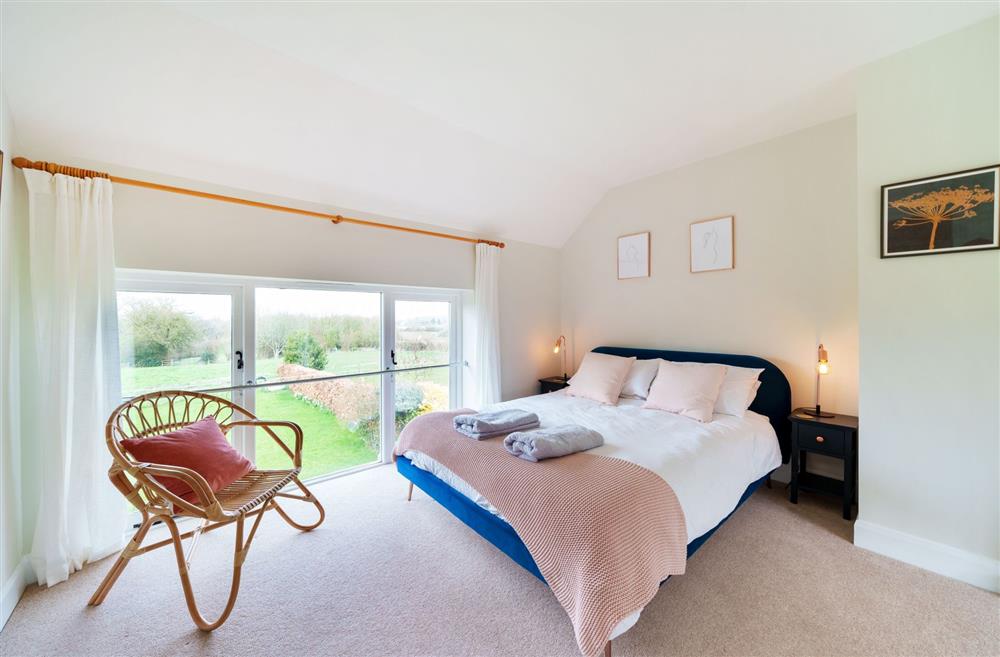 Bedroom one has great views of the garden and across the countryside at Byre House, Blandford