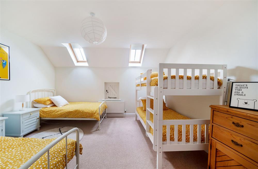 Bedroom three with its 3’ twin beds and full-size bunk beds . at Byre House, Blandford