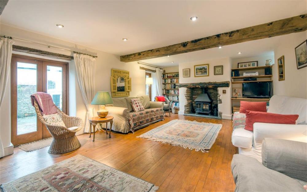 The spacious sitting room with cosy woodburner. at Byre in Slapton