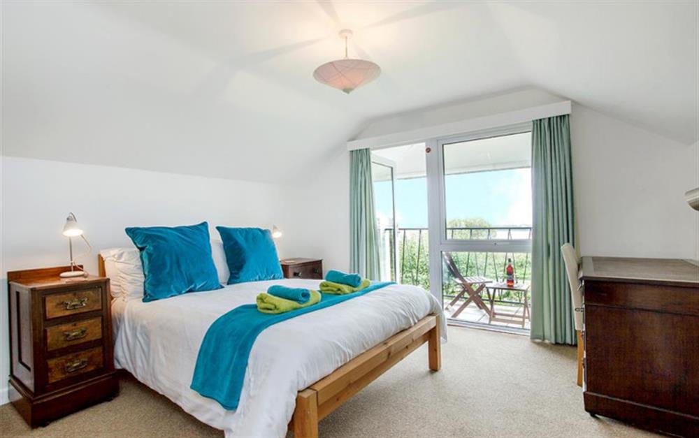 The master bedroom with balcony and views over the ley. at Bywater in Torcross
