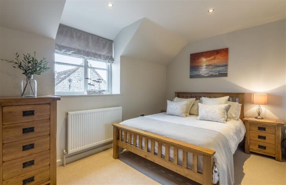 First floor: Bedroom two with king-size bed at Caddows, Docking near Kings Lynn