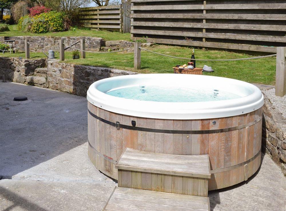 Luxurious hot tub within rear courtyard at The Farmhouse, 