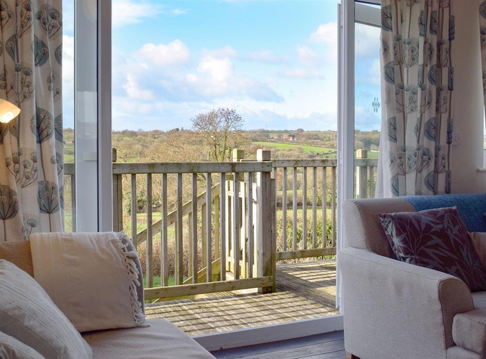 Patio doors, in the living room, leading through to stunning view of the countryside at Cae Gwyrdd in Cardigan, Dyfed