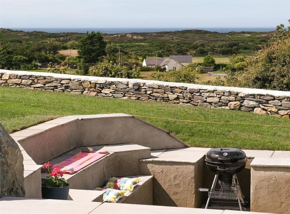 Sunken seating and bbq in the garden at Pant y Saer, 