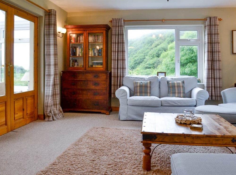 Living room with French doors to conservatory at Caefadog Fach in Barmouth, Gwynedd., Great Britain