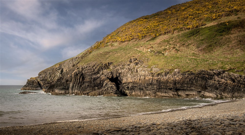 The cliffside and pebble beach at Caerllan in Llandysul, Ceredigion