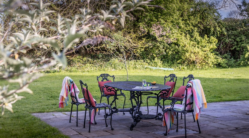 The garden patio with outdoor dining furniture at Caerllan in Llandysul, Ceredigion