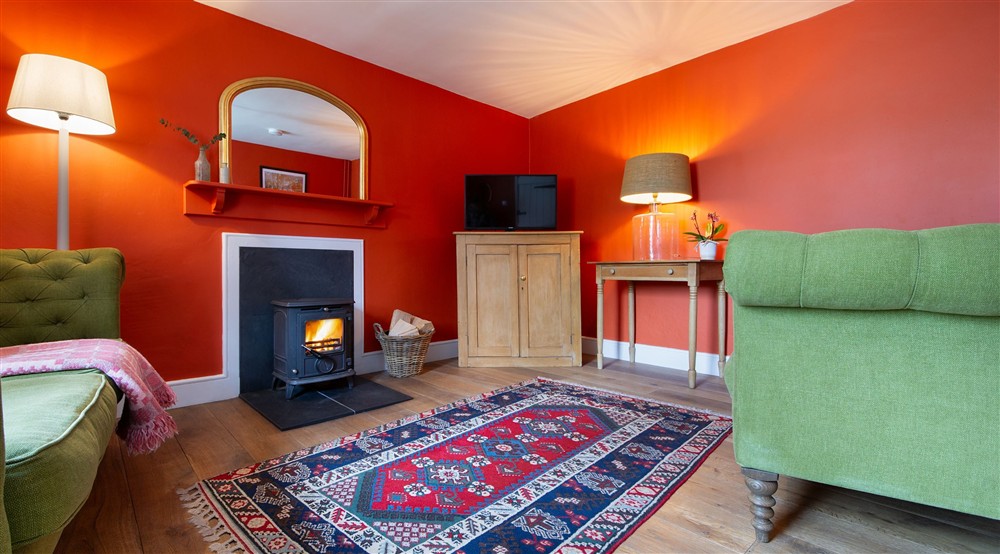 The sitting room with woodburner (photo 2) at Caerllan in Llandysul, Ceredigion