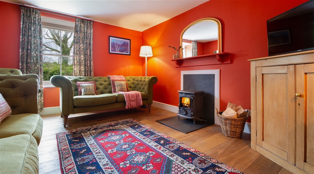 The sitting room with woodburner at Caerllan in Llandysul, Ceredigion