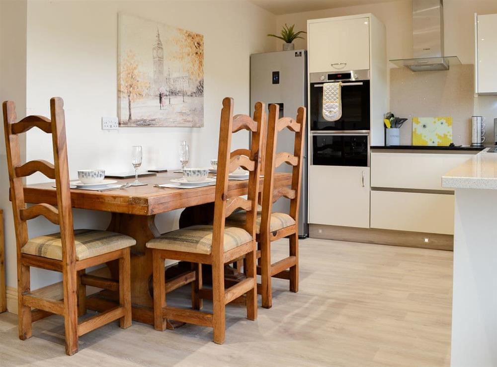 Dining and adjacent kitchen area at Woodedge, 