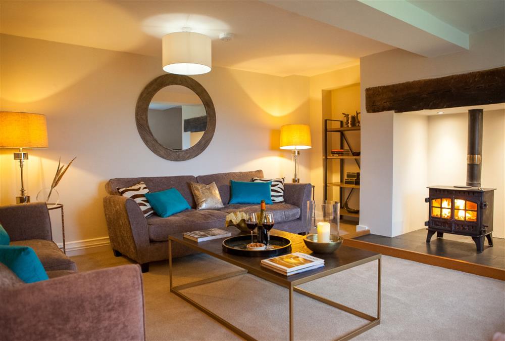 Relax in the beautiful sitting room in front of the wood burning stove at Calcot Farmhouse, Montgomery