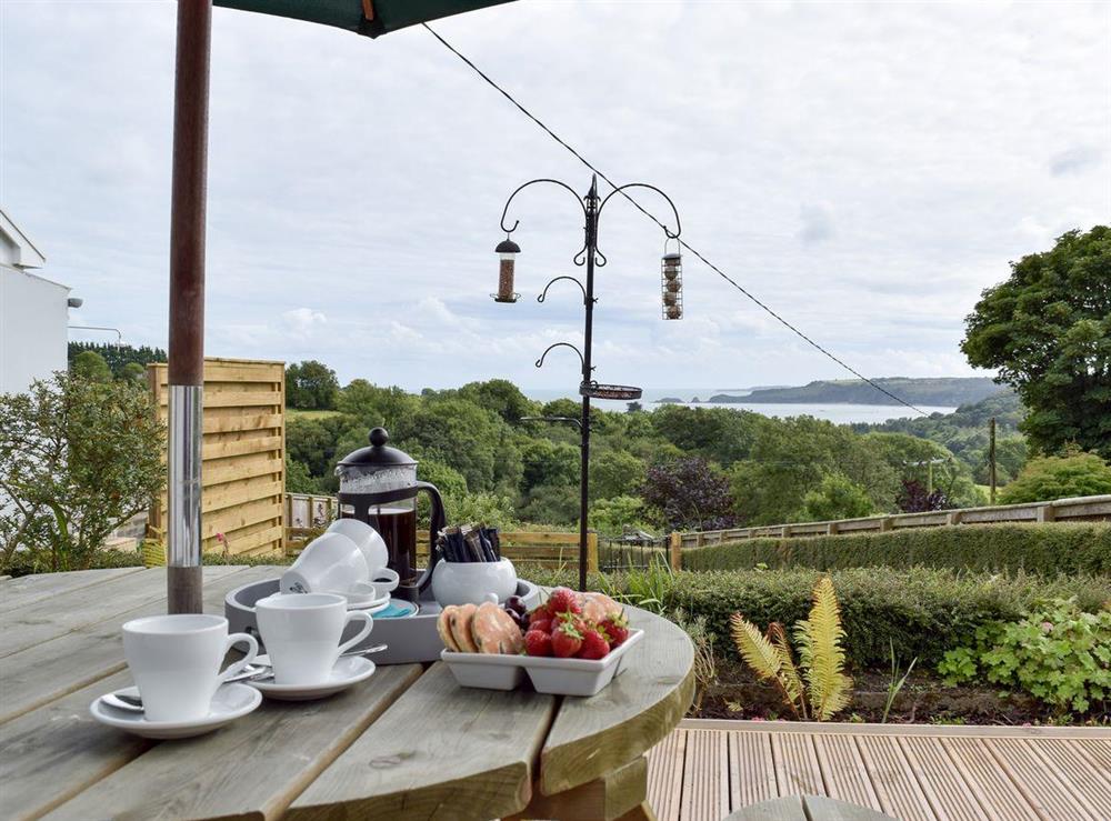 Outdoor dining area with views at Caldey View in Near Stepaside, Saundersfoot, Pembrokeshire, Dyfed
