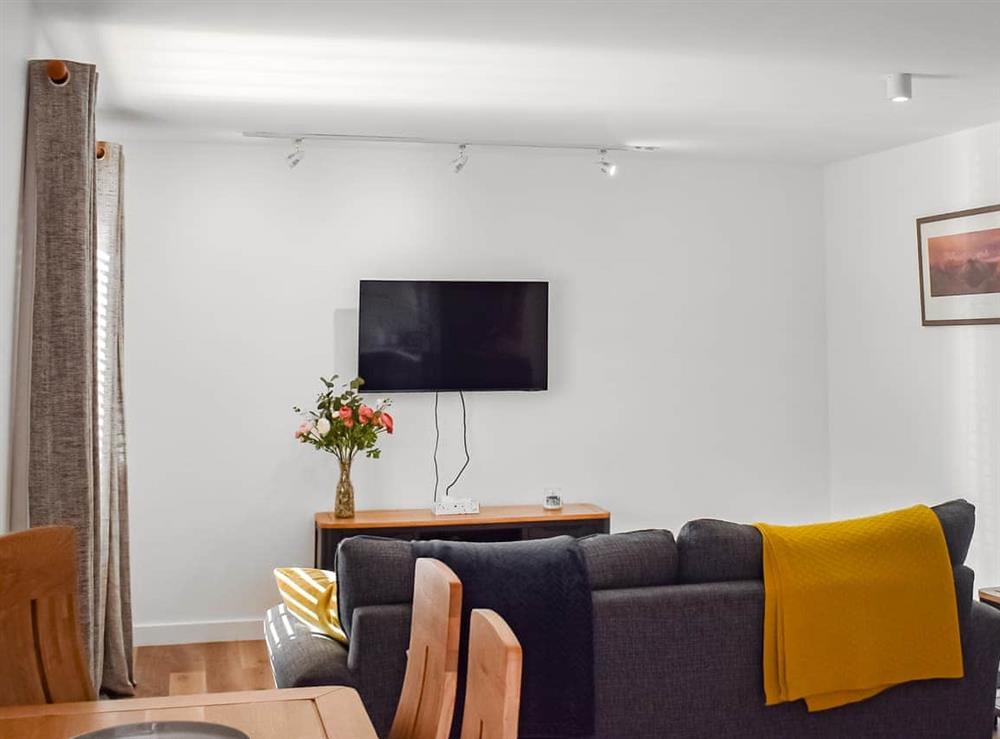 Open plan living space at Caledonia Apartment in Aviemore, Inverness-Shire