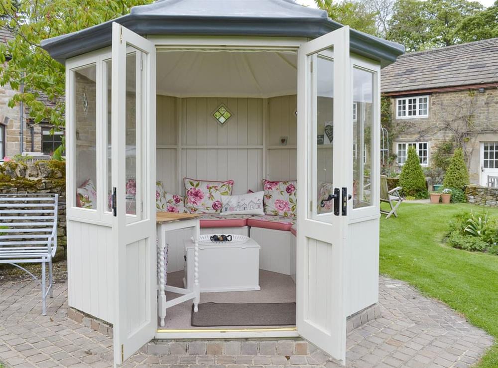 Summerhouse in shared gardens at Calico Cottage in Hope Valley, South Yorkshire