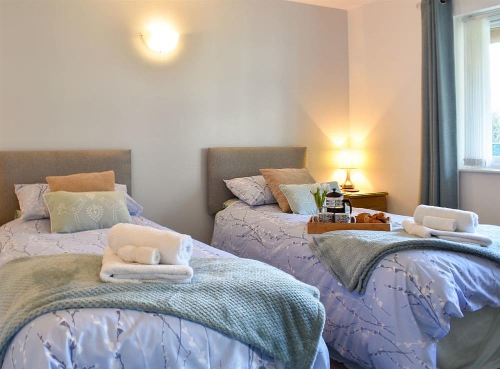 Relaxing twin bedroom at Camelia Cottage in Polmassick, near St Austell, Cornwall, England