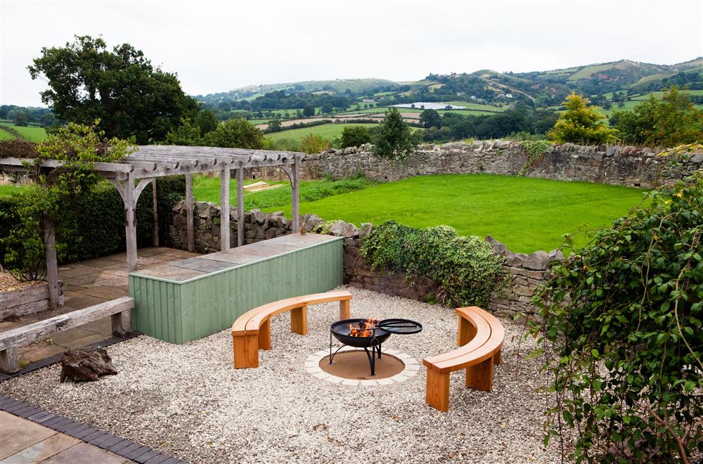 The patio with fire pit and seating at Camlad Barn, Montgomery