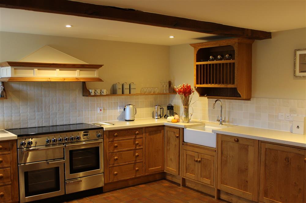 Well-equipped, spacious kitchen with exposed beams at Camlad Barn, Montgomery