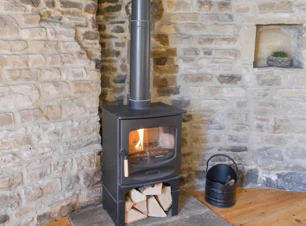 Woodburner within the feature fireplace at Campanula House in Askrigg, North Yorkshire