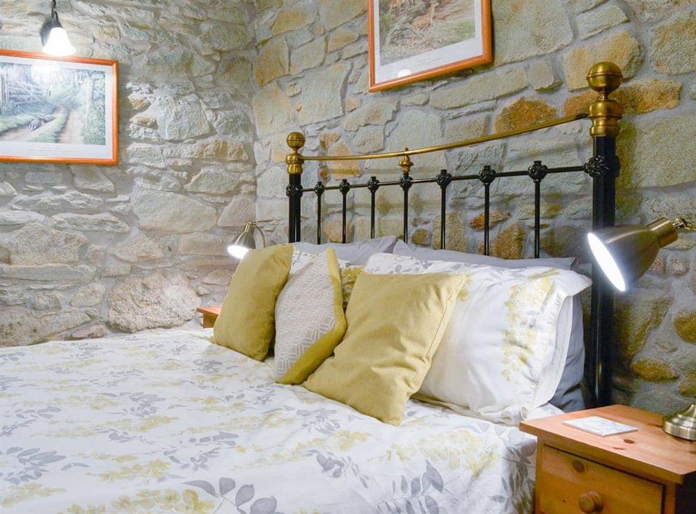 Double bedroom boasting an antique stlye double bed at Campion Cottage in Michaelstow, Nr Camelford, Cornwall., Great Britain