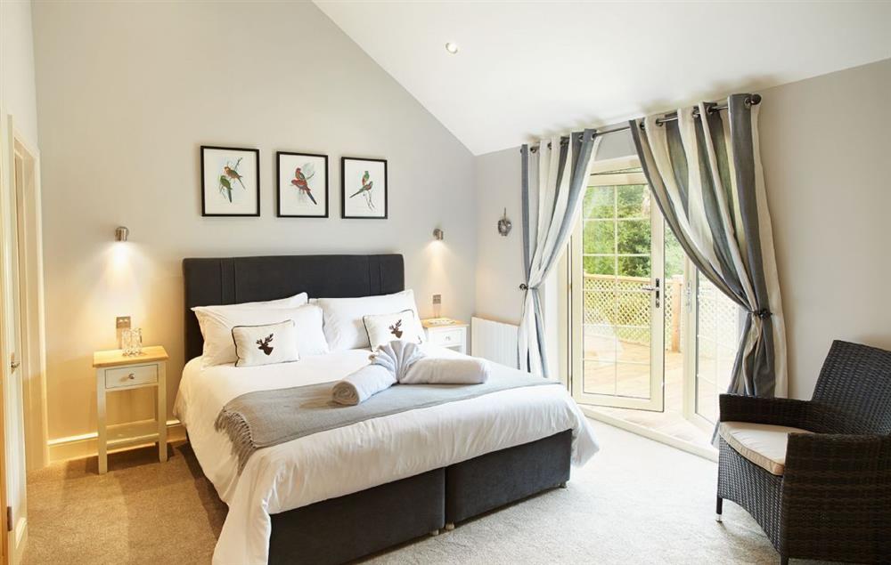 Master bedroom with 6’ bed and en suite bathroom with separate shower at Campion Lodge, Wakes Colne