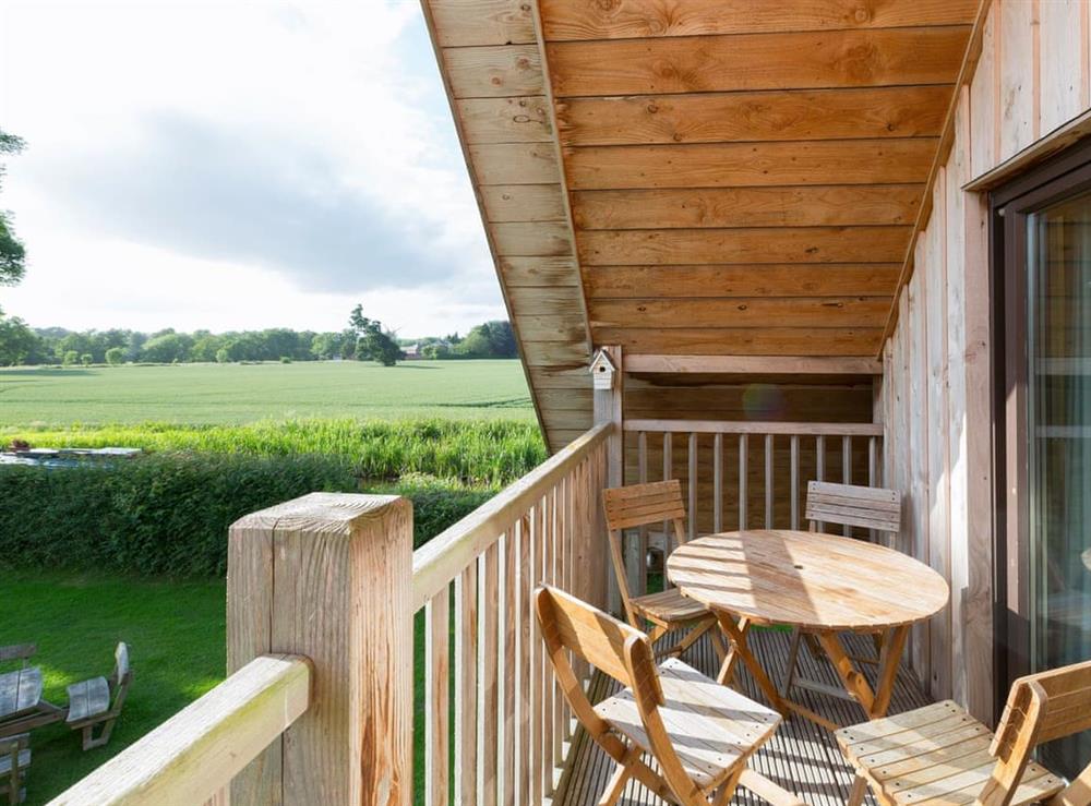 Covered balcony with views over the canal and beyond at Canal Central in Maesbury Marsh, near Oswestry, Shropshire