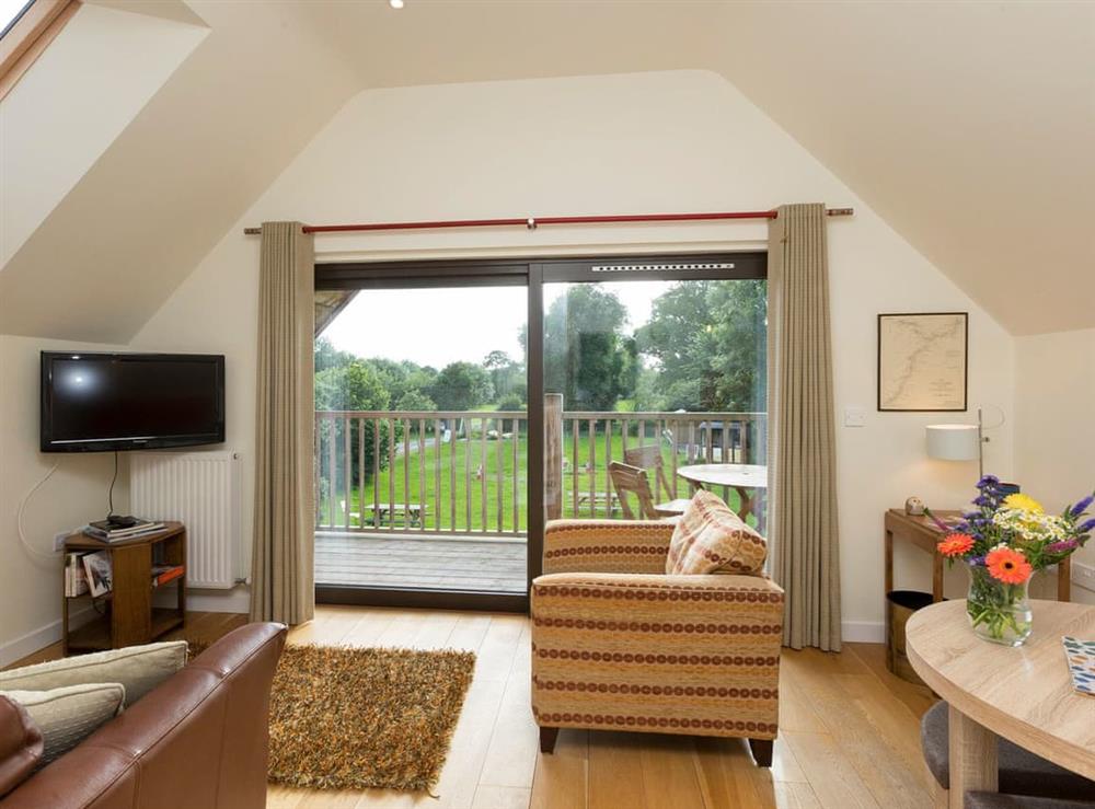 Spacious living area with sliding door access to balcony at Canal Central in Maesbury Marsh, near Oswestry, Shropshire