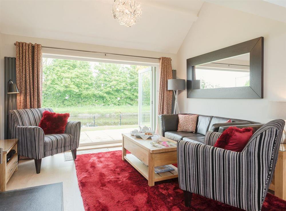 Spacious living room with opening doors with fantastic view at Canal View in Tetchill, near Ellesmere, Shropshire
