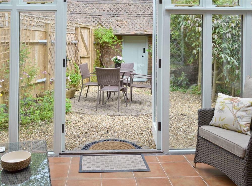 Conservatory adjoins rear courtyard with sitting out area