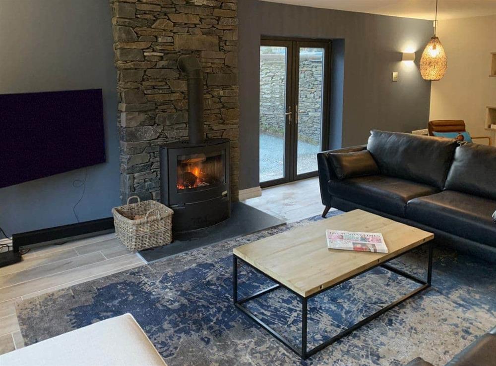 Welcoming living area with wood burner at Cannondale in Annisgarth, near Windermere, Cumbria
