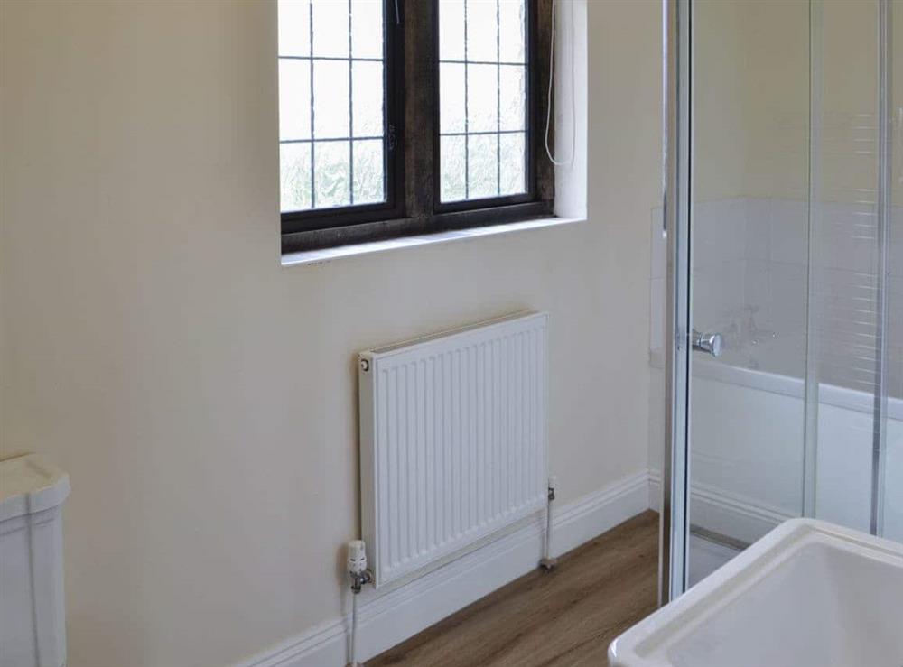 Bathroom with bath and shower cubicle at Canon Court Farmhouse in Milborne Port, near Sherborne, Dorset