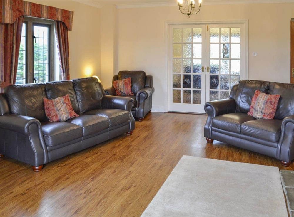 Comfortable leather furniture and wooden floors at Canon Court Farmhouse in Milborne Port, near Sherborne, Dorset