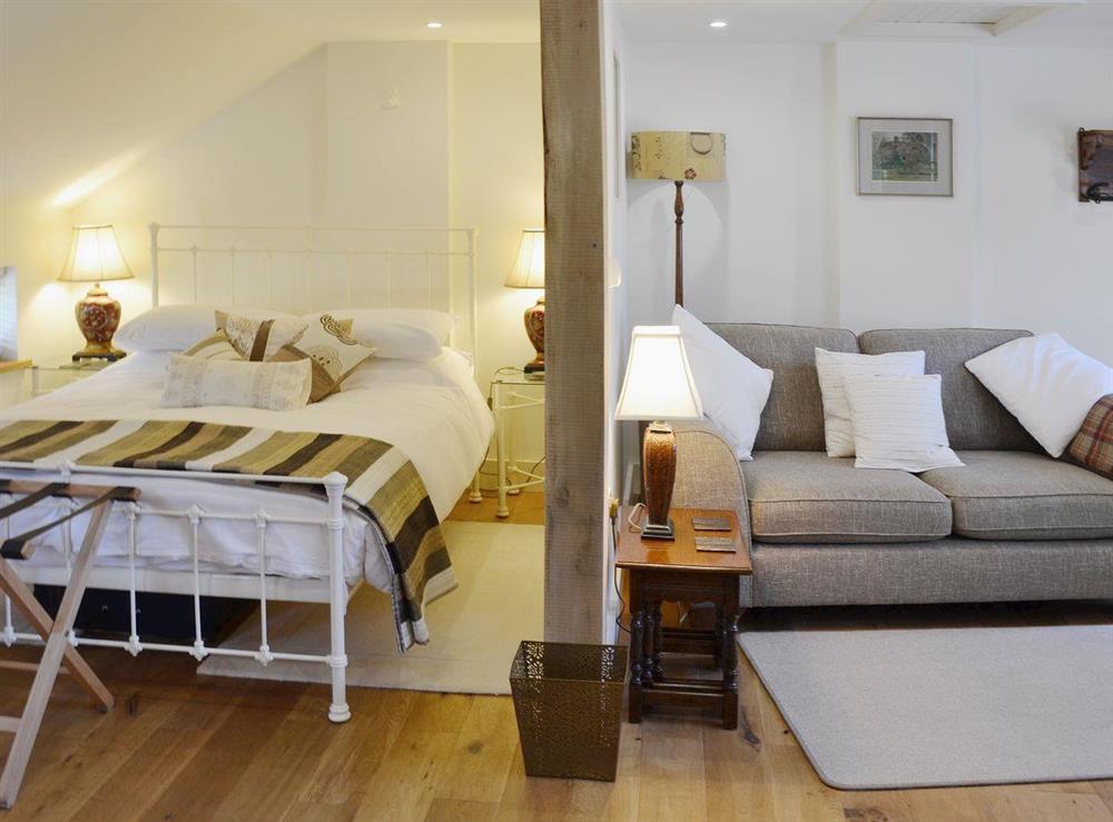 The light and airy bedroom is adjacent to the living area at The Gardeners Cottage, 
