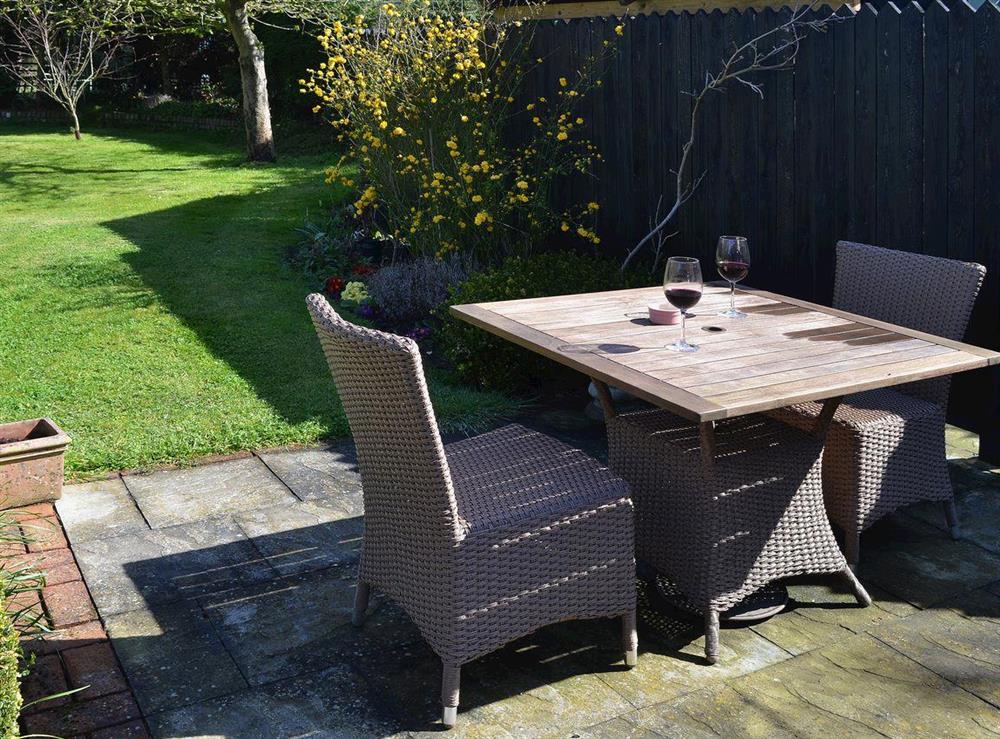 The patio is an ideal spot to have an outdoor meal or relax with a glass of wine at The Gardeners Cottage, 