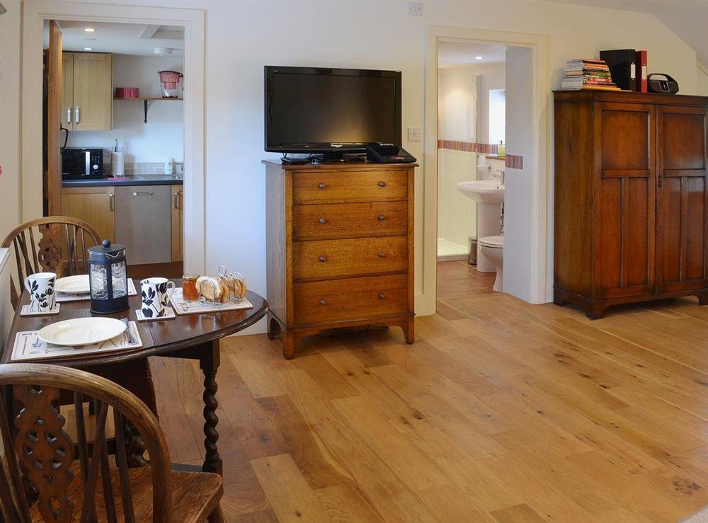 The stylish living/dining room has an oak floor at The Gardeners Cottage, 