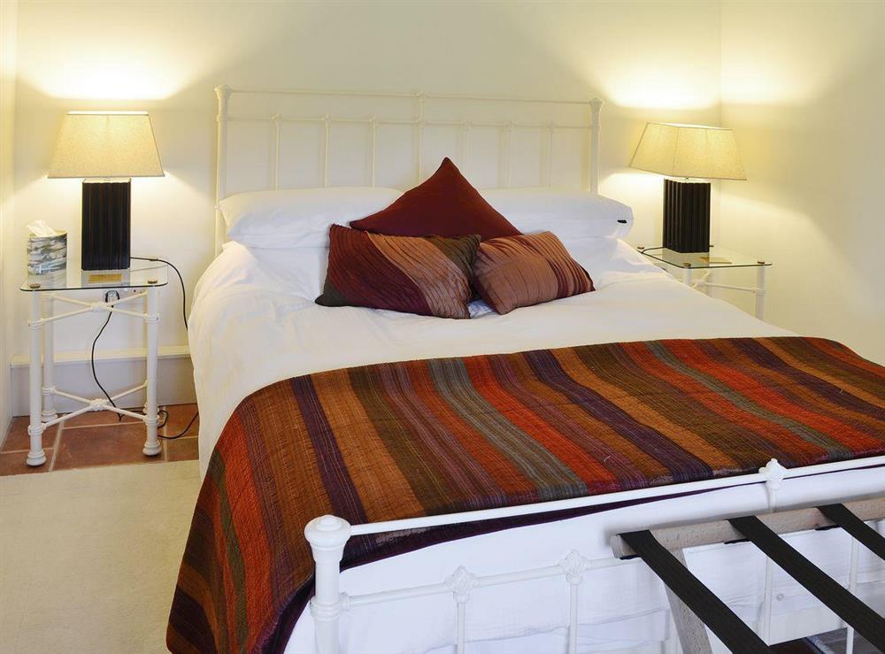 The bedroom boasts a kingsize bed at The Stables, 